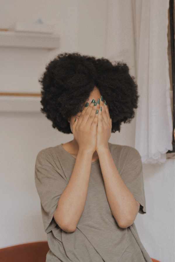 A woman covering her face