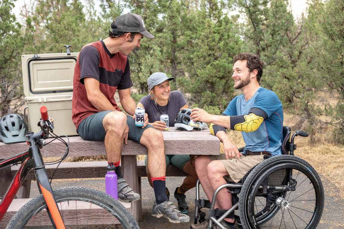 A group of friends in a counselling group session with one of them in a wheelchair